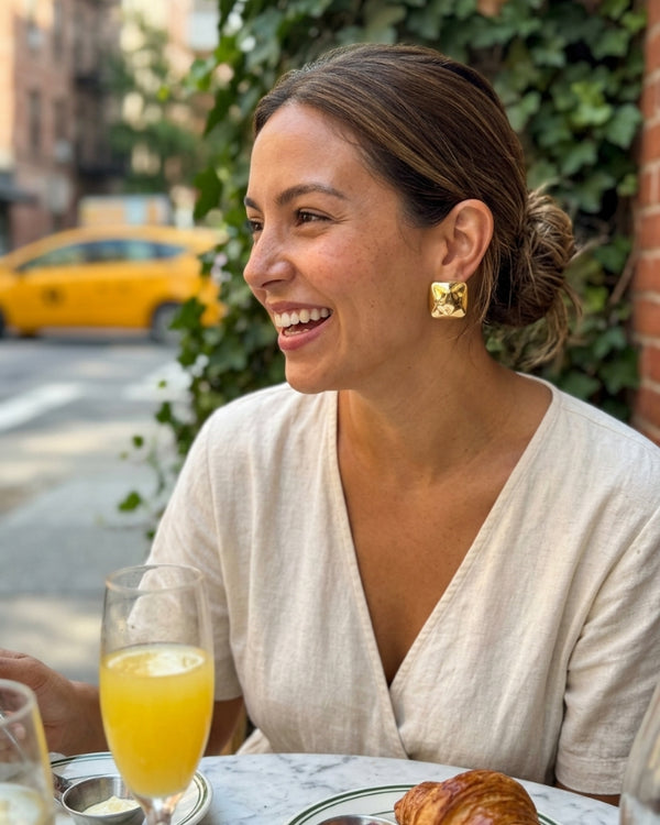 AMINA O. wearing the Stella Statement Stud Earrings