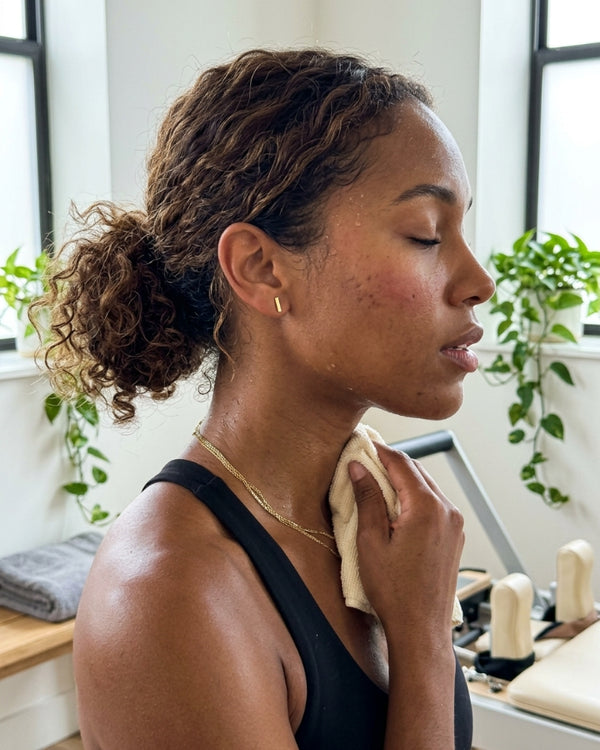 TANIA M. wearing the Vela Drop Bar Earrings