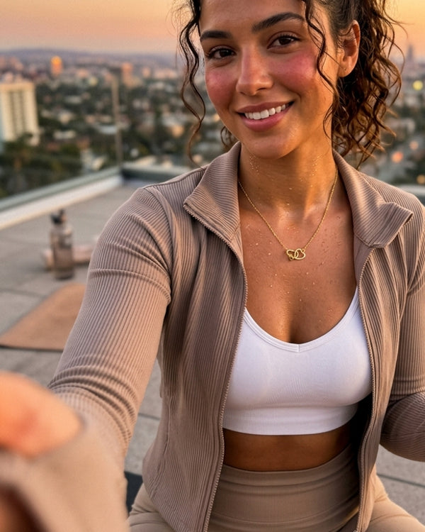 OLIVIA B. wearing the Amara Double Heart Necklace